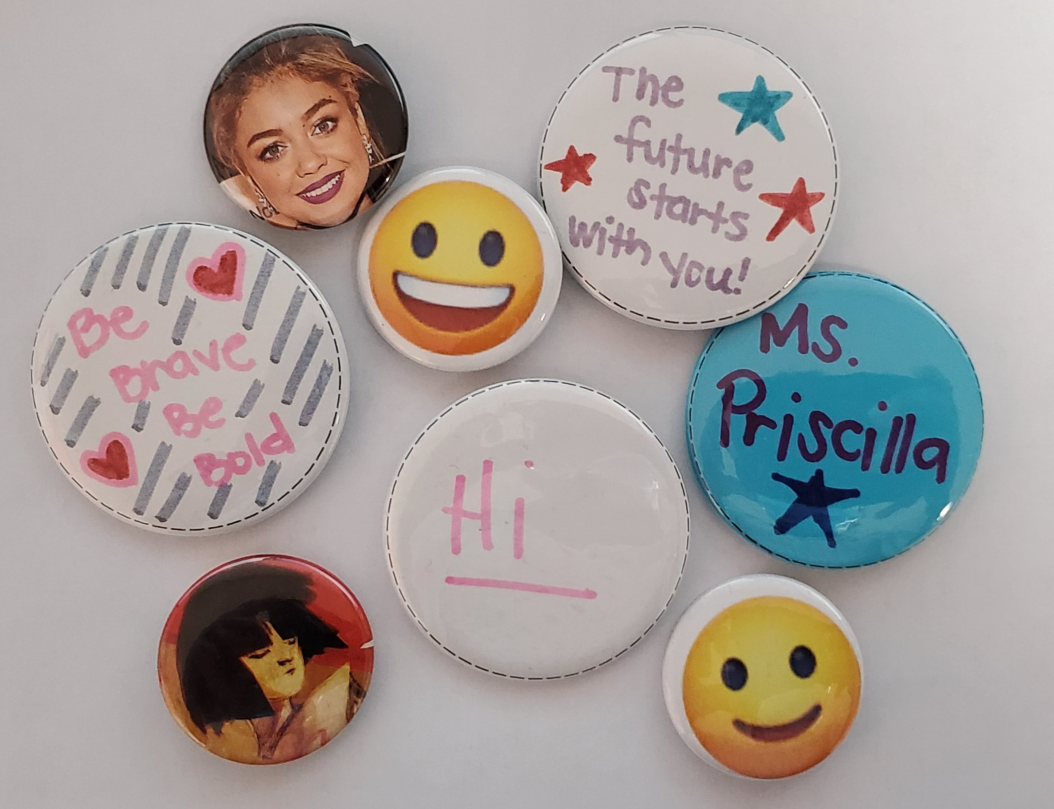 Buttons of varying size with images on the front.